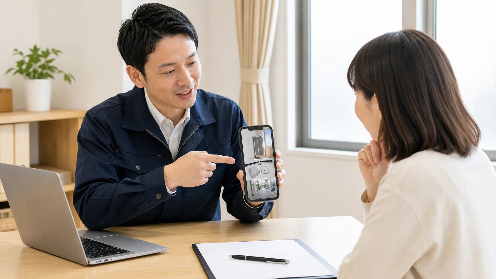 窓用エアコンの写真を見ながら回収方法を相談する様子